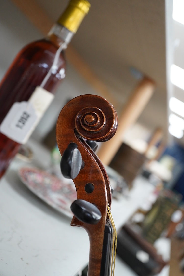 A late 19th century German violin after Pablo Maggini in bird’s eye maple with a fully mounted German bow in a crocodile skin case with retailers ivorine label reading; ‘Edward Withers, 22 Wardour Street, phone City 1899